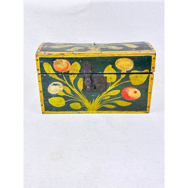 A wonderful antique polychrome trunk from France. Painted with a floriculture theme. The vibrant trunk, which was hand-...