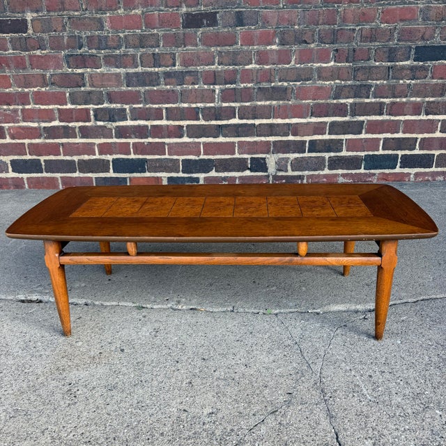 This is a gorgeous Lane coffee table, style number 1921. It features a nice walnut frame with set of 18 Burlwood squares...