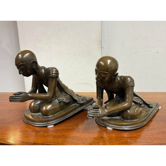 Design Plus Gallery presents a Pair of Bronze Southeast Asian Buddhist Monks. These monks are similar but not alike with...