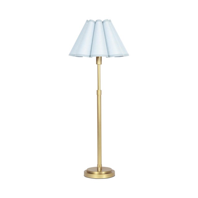 The Polly Buffet Table Lamp showcases sophistication with its single scalloped shade, casting a warm and inviting glow...