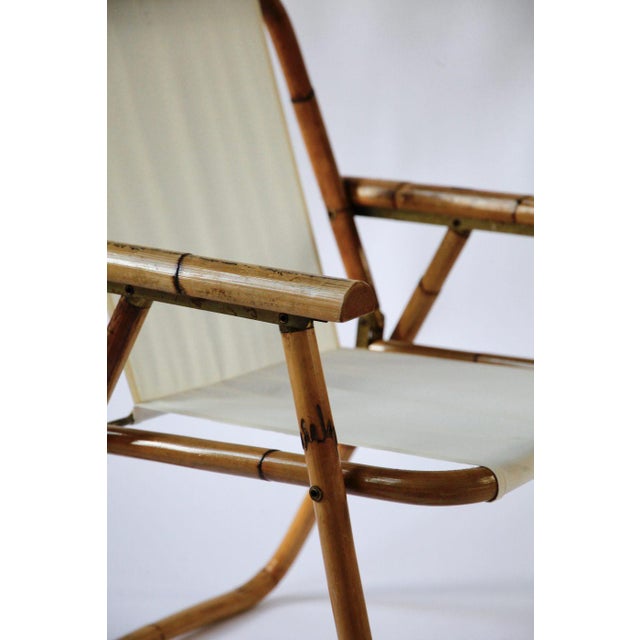 A folding chair from italy, dating to the 1960s and attributed to raffaella crespi. the frame is made from bamboo, with...