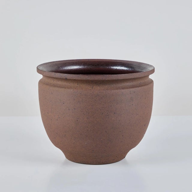 A hand thrown stoneware bowl planter from California ceramicist Robert Maxwell. The planter has a rounded lip and speckled...