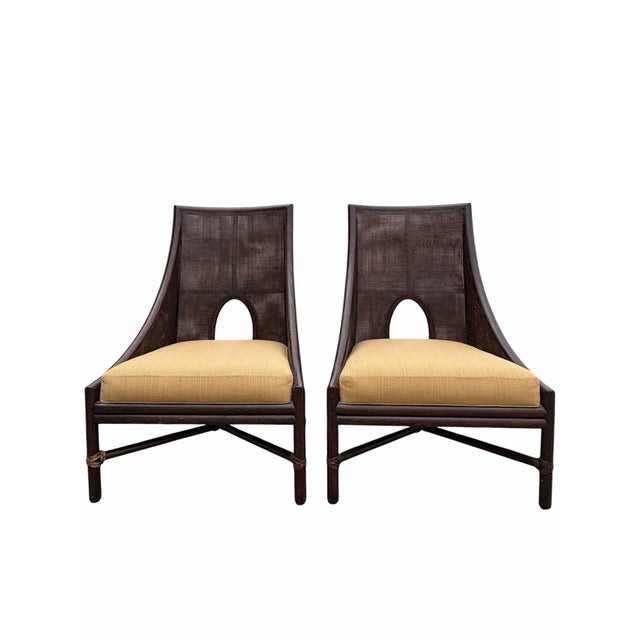 Offered here is a pair of caned lounge chairs designed by Barbara Barry for McGuire Furniture. The chairs feature a...