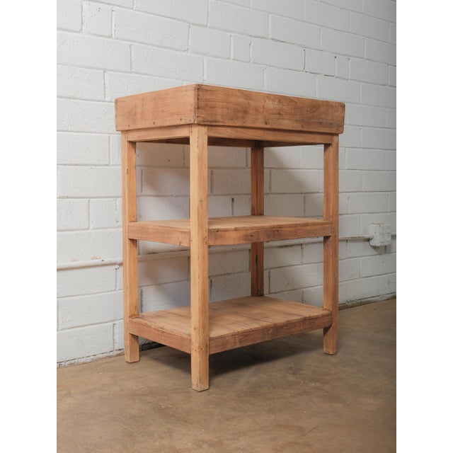 This handcrafted Indian wooden shelving unit features a timeless, utilitarian form rooted in traditional workshop...
