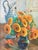 A luminous French mid-century still life of orange sunflowers and a delft vase set in a powder blue room. This oil on...