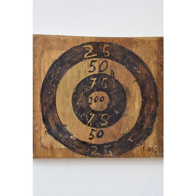 Vintage Make-Do Bullseye Target, Circa 1970s. Hand-drawn dartboard in black permanent marker on a slab of wood. A four-...