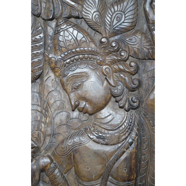 Bring timeless artistry and spiritual elegance into your home with this antique hand-carved wooden wall panel depicting...