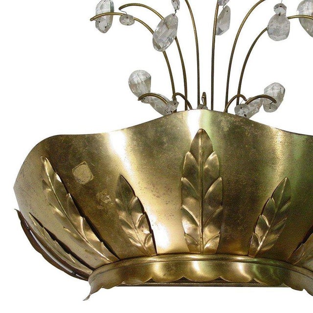 A pair of Art Deco Brass palm wall sconces with decorative arms and ornamental crystals. Handcrafted with a scalloped...