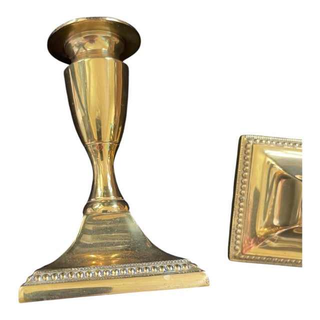 Pair of midcentury vintage candle holders/candlesticks made from polished brass. Made to reflect Georgian style with a...