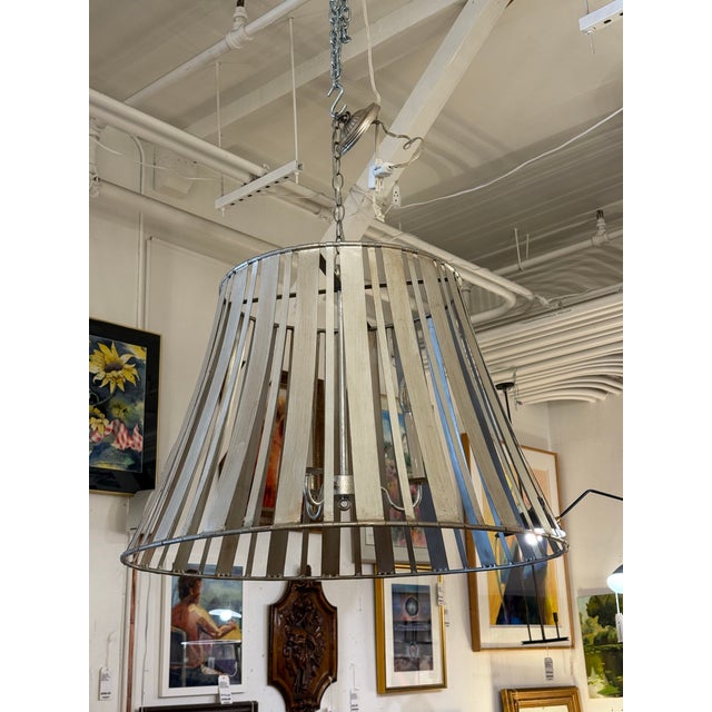 Design Plus Gallery presents a Rustic Industrial Lattice Drum Chandelier. This chandelier has a wide tapered drum shade...