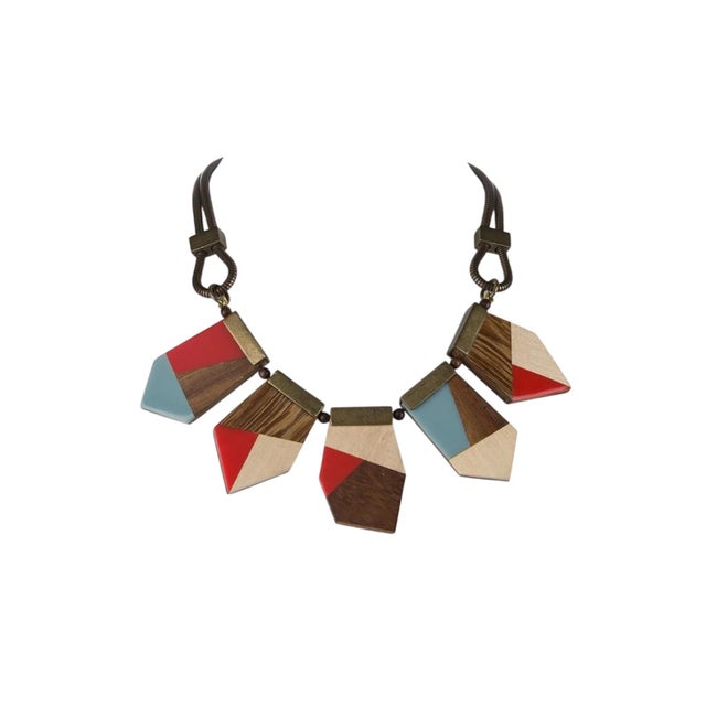 This statement necklace by designer Lela Rose is made up of geometric wood and resin elements. Known for her bold,...