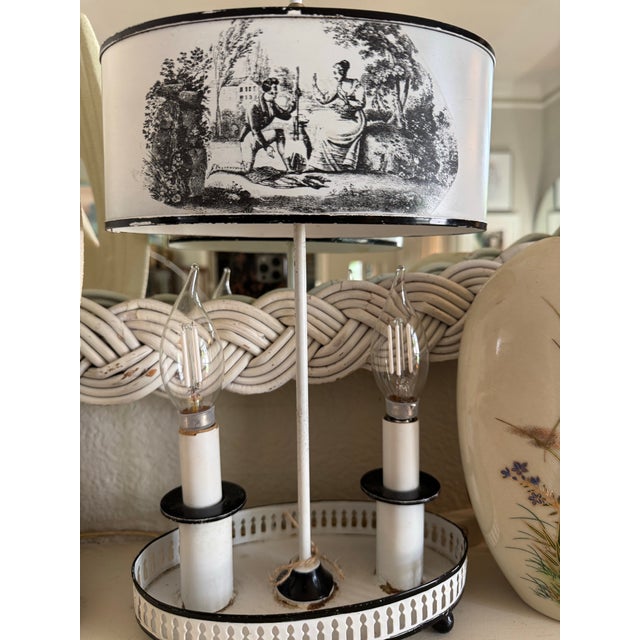 The metal/ tole lamp features a white-painted metal tray base. It has dual sockets where we’ve added candle flame bulbs...