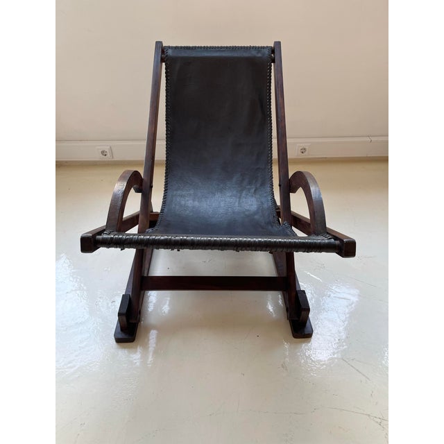 Brazilian style Lounge chair, solid wood frame, curved arms, leather seat, mounted in a sling style (suspended). This...