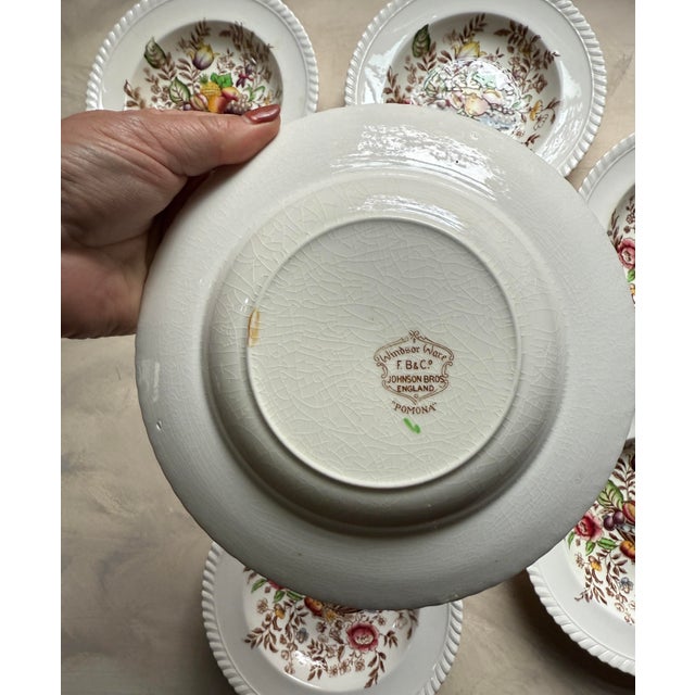 A charming set of seven vintage English soup bowls from Johnson Bros., England, in the beloved “Pomona” pattern — part of...