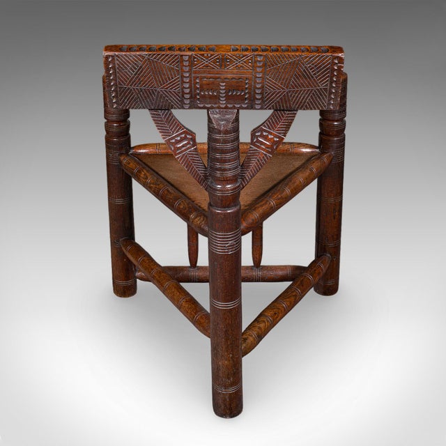 This is an antique Old Saxon armchair. An English, oak Turner's chair or elbow seat, dating to the late Victorian period,...