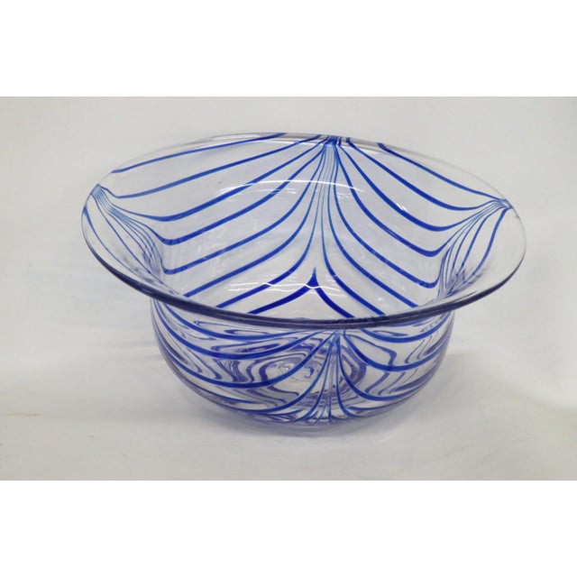 This gorgeous Serving Bowl is made of hand blown art glass. This stunning centerpiece bowl features a wide flared rim...