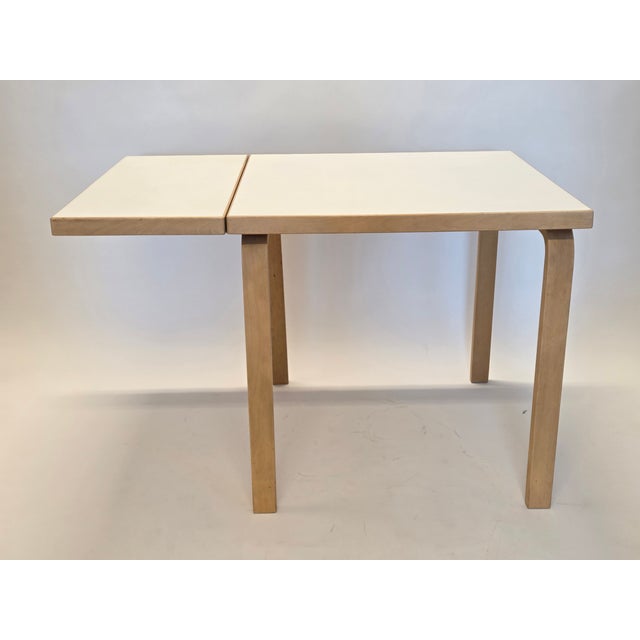 Artek folding table, birch with white laminate. Designer Alvar Aalto. The table is from the 1960s. Good used condition....