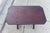 This table showcases a rich, dark reddish-brown color, characteristic of mahogany wood. The table features a rectangular...
