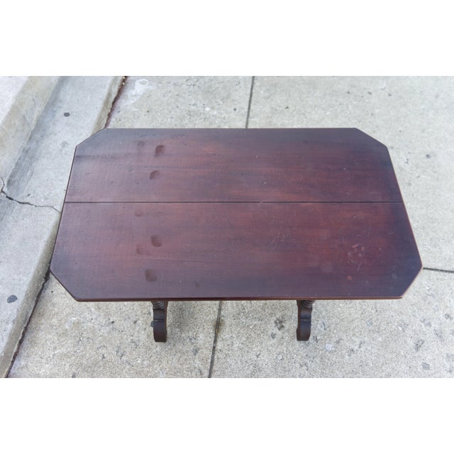 This Spanish style accent table showcases a rich, dark reddish-brown color, characteristic of mahogany wood. The table...