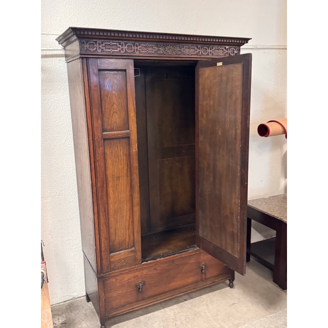 Design Plus Gallery presents an Antique Carved Oak Mirrored Wardrobe from Ray & Miles of Liverpool. The tall cabinet...