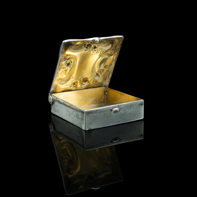 This is an antique postage stamp box. An American, silver pocket case with monogram, dating to the Edwardian period, circa...