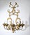 This gilded wrought-iron wall sconce is an elegant expression of classic decorative style, reminiscent of the creations of...