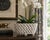 An elegant trompe l'oeil porcelain cachepot crafted in the form of a handwoven rope basket. Executed in glossy white...