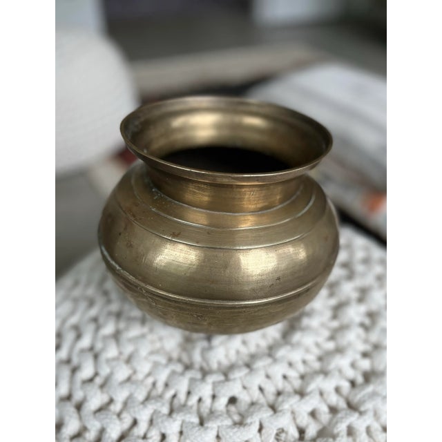 The handcrafted origin of this little pot gives way to its little tilt. Perfect as a modern day accent piece or planter.