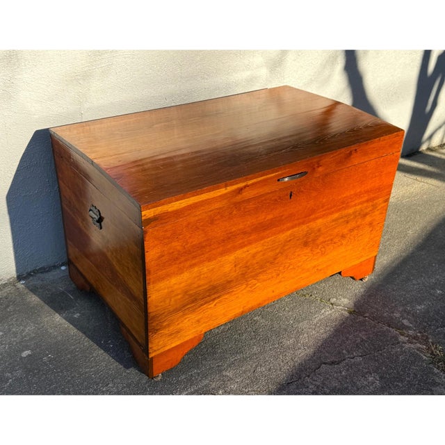 Solid wood hope chest with warm grain and a straightforward, functional build. Clean lines with a slightly raised base,...
