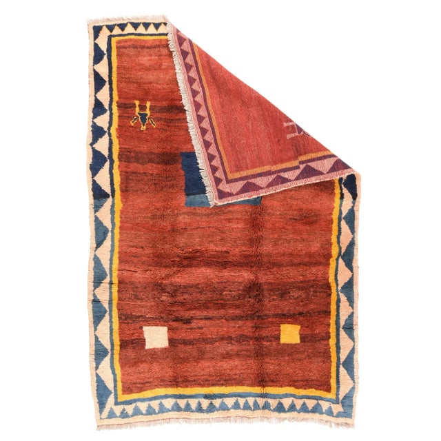 This well-colored SW Persian Qashghai nomadic scatter features an abrashed red field with two gesticulating human figures,...