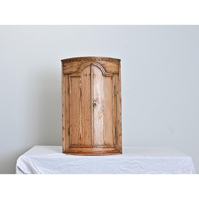 A Swedish 19th century corner cabinet with the most incredible carvings and lively blue interior that belies the humble...