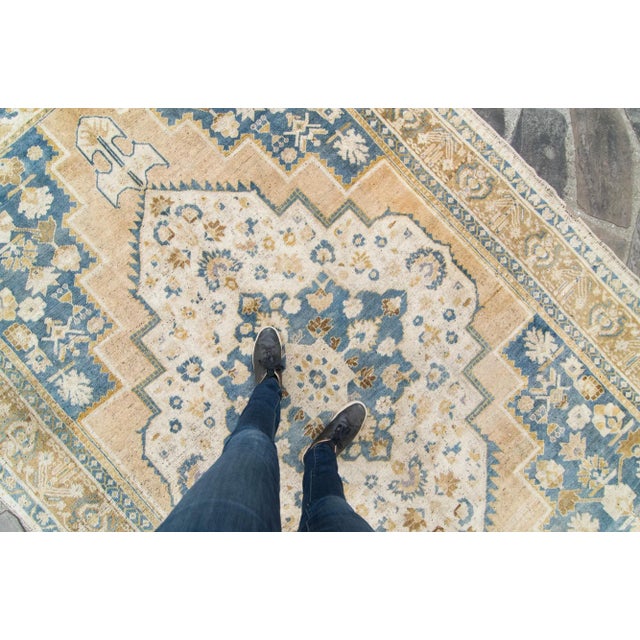 A medallion and geometric pattern design adorn this hand-knotted Anadol rug, featuring colors such as goldenrod with corn...