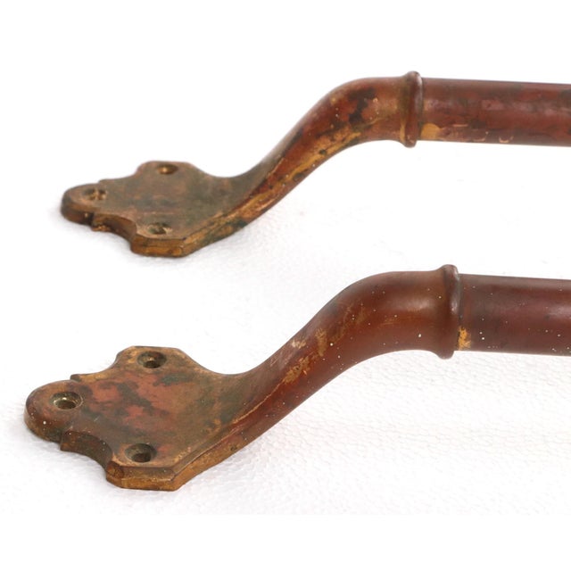 Vintage brass door push bars in a straightforward geometric design with subtle detailing. Mounts with three screw holes...