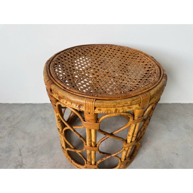 Add a touch of organic charm to your space with this vintage boho chic bamboo side table, designed in a classic drum form....