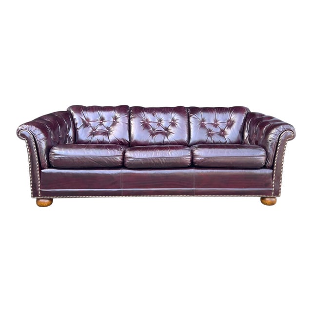 This striking vintage leather sofa beautifully captures the timeless sophistication of classic English Club design....