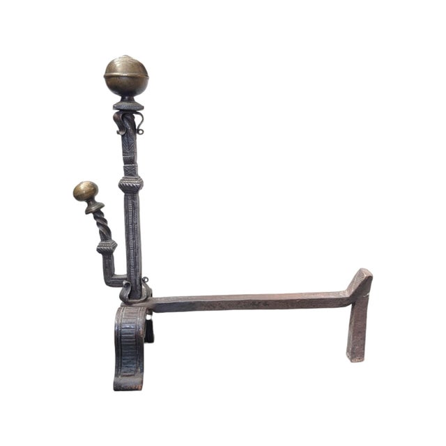 Antique Spanish Revival fireplace andirons with aged brass spherical finials and dark patinated wrought iron frames. Each...
