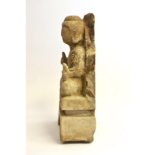 A 19th century antique stone Buddha, weighing 23 lbs, depicting a young Shakyamuni. His full, rounded face—typical of the...