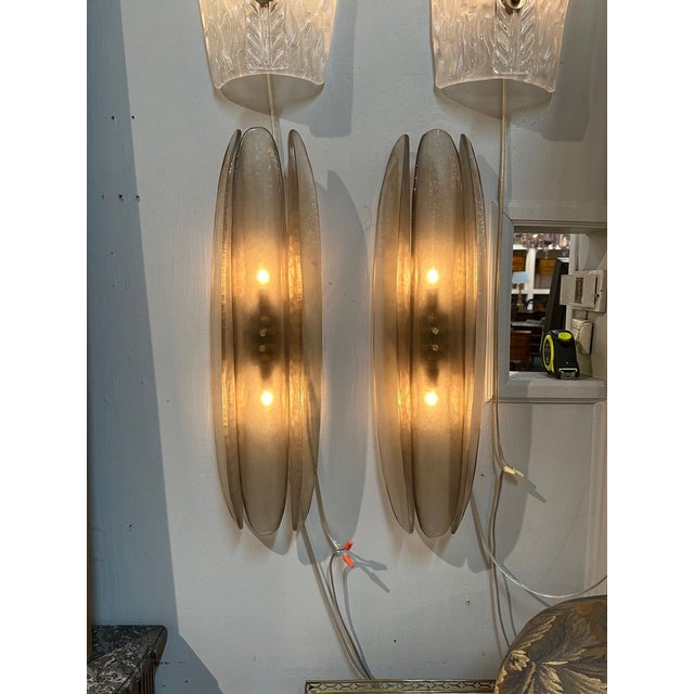 Stylish pair of "Fume" Murano glass sconces. Featuring layers of glistening glass. Very nice!