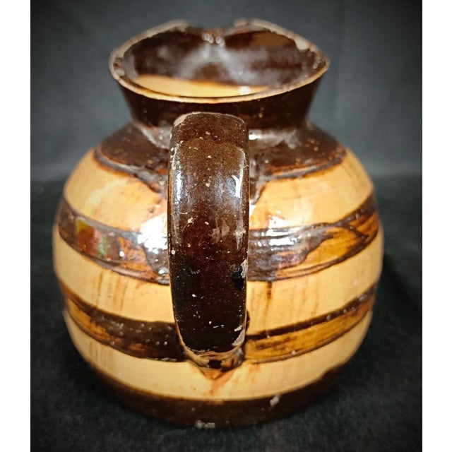 Bring a touch of rustic charm to your collection with this vintage hand-painted clay pitcher, designed in a distinctive...