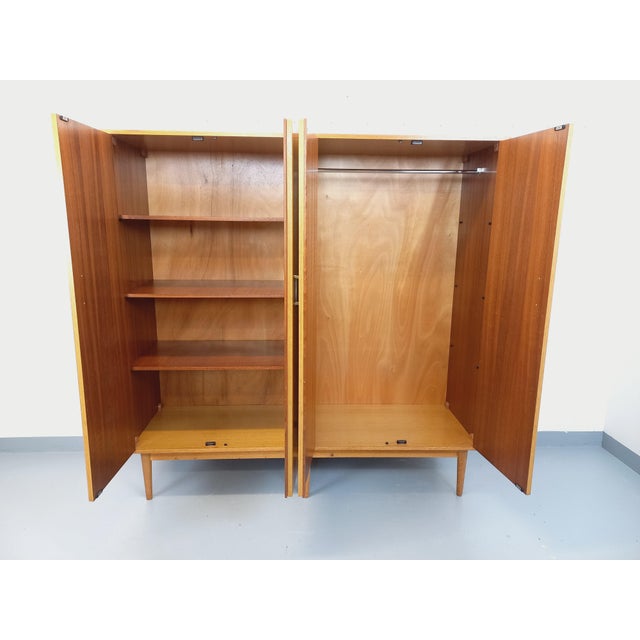 Vintage 1960s wardrobe in oak, with splayed legs, brass fittings and handles, and an oak and mahogany interior. Ample...