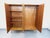 Vintage 1960s wardrobe in oak, with splayed legs, brass fittings and handles, and an oak and mahogany interior. Ample...