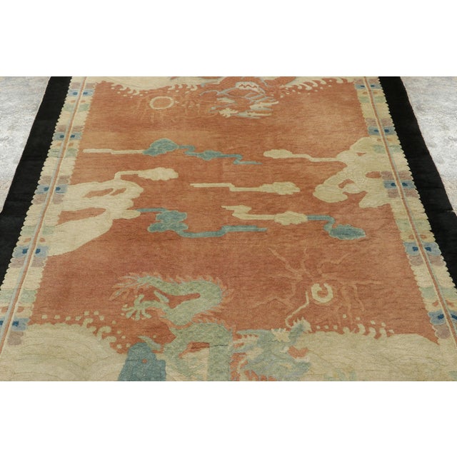 Made with hand-knotted wool circa 1920-1930, this 5x8 antique Chinese rug is a vibrant exemplar of the Art Deco period....