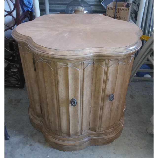 This mid-century cabinet features a distinctive clover shape on its top and base, contributing to its unique aesthetic....