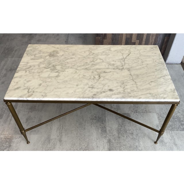 Vintage 1960s coffee table White marble top with gray veining in very good condition with minimal imperfections Gilt brass...
