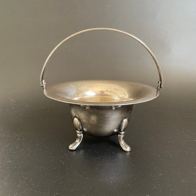 A Deco silverplate on nickel silver serving bowl by Empire Silver Company, featuring a Greek Key handle and claw feet....