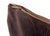 This pillow has a rich chocolate-brown fabric with a smooth, velvety texture that gives it a luxurious feel. The edges are...