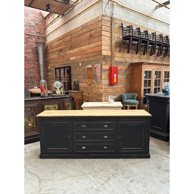 This antique patinated sideboard has been fully restored. It has two large lockable doors opening onto a shelf and three...