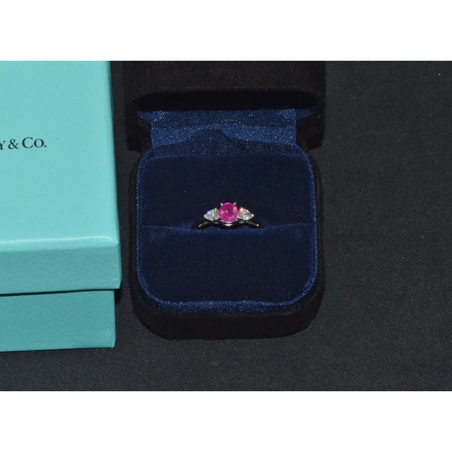 Genuine Tiffany & Co. 950 platinum 1.15CTS diamond and ruby ring. This gorgeous three stone engagement ring features a...