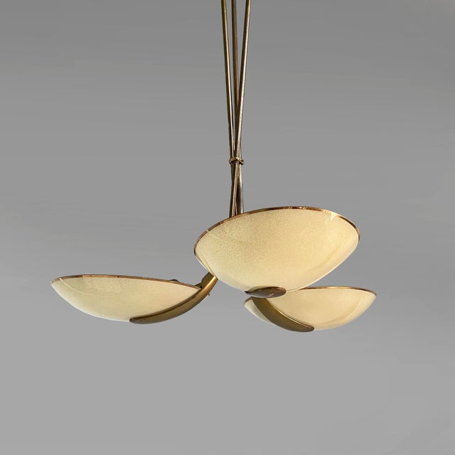 Italian mid-century modern chandelier in glass and brass, 1950s Chandelier with three oval yellow glass shades with gold...
