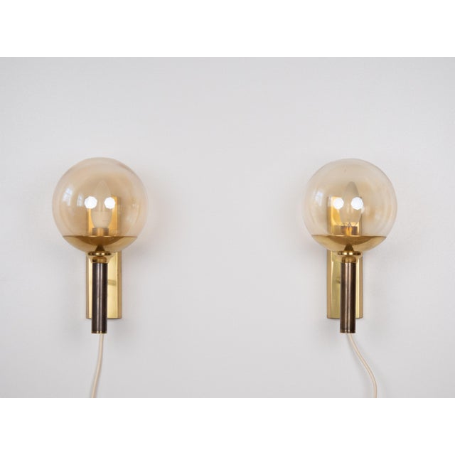 For sale: a set of two retro-modern wall sconces made of brass and smoked glass. Inspired by classic Scandinavian design...